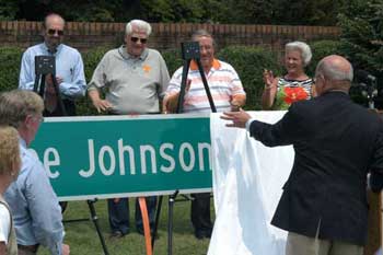 Photo: Dr. Joe Johnson unveiling new road sign.